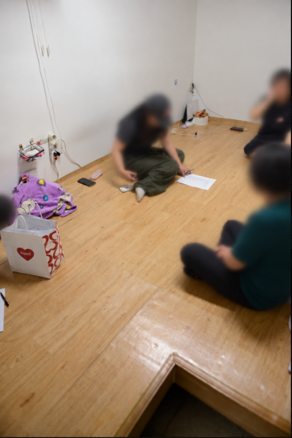 301관 3층 휴게시설에서 환경노동자들이 바닥에 앉아 있다.